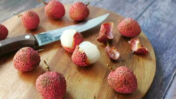 Lychee on a chopping board on wooden background video