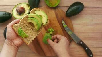 Aguacate en una rebanada de pan integral en la mesa video