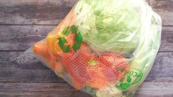 top view of vegetables in a plastic shopping bag on floor video