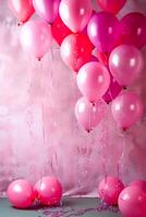 Bunch of pink and red balloons floating in the air with streamers. photo