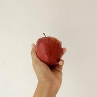 Hand Holding a Fresh Red Apple photo