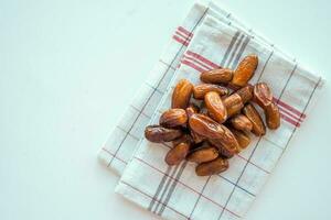 top view of fresh date fruit in a bowl on table photo