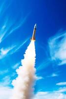 Rocket that is flying through the air with smoke coming out of it. photo