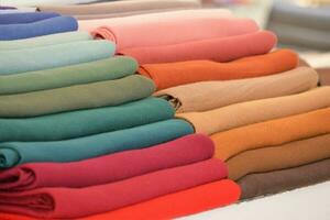 stack of colorful cloths on table. photo