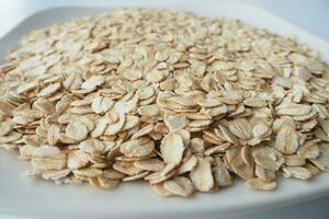 roasted oats flakes on a white plate photo