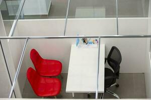 Empty workplace with white table and red chair top view. photo