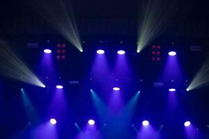 Blue background with stage light white and pink beams. photo