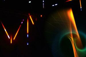 Colored multicolored rays and swirls from the stage light on a dark background. photo