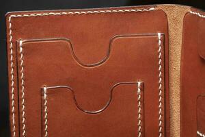 Part of a brown leather wallet or purse close-up. photo