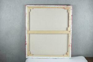 Wooden frame from the picture on the back against the background of the gray wall. photo