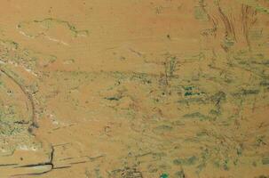 The texture of the surface painted with old yellow peeling oil paint. photo