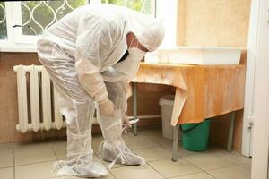 The doctor takes off his protective suit in the hospital during the coronavirus epidemic. photo