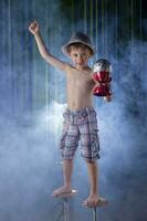 A little boy circus performer performs against the backdrop of stage lighting. photo