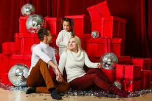 family, christmas, x-mas, winter, happiness and people concept - smiling family with many gift boxes photo