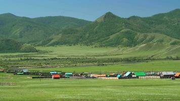 Colorful Houses of a Russian Town in Forest and Meadow By River in Siberia, Russia video