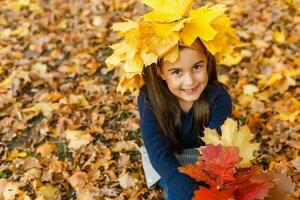 happy little child, girl laughing and playing in the autumn on the nature walk outdoors photo