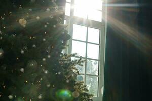 Decorated Christmas tree on blurred, sparkling and fairy background photo