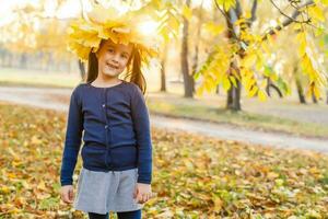 Autumn season leisure. Atmosphere of autumn. Adorable smiling schoolgirl autumn foliage background. Good mood. Happy child. Welcome october. United with nature. Little child walk in autumn park. photo