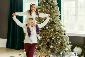 christmas, x-mas, winter, happiness concept - mother and daughter have fun photo