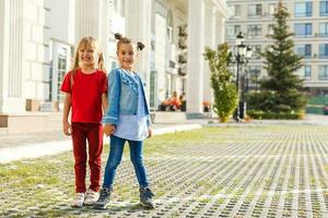 Portrait of happy fashion little girls having fun in the city photo