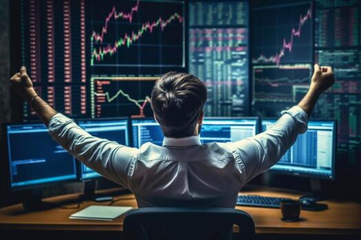 Back view of bearded young businessman woking with graph and charts on computer photo