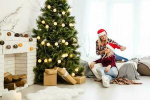 Two girls lie on the bed and smiling. Christmas feeling. After Christmas party. photo