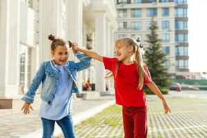 two little girls dancing in the street photo