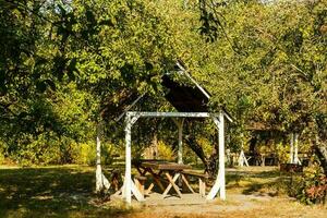 wooden gazebo in the autumn park photo