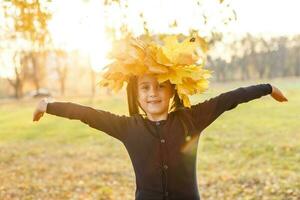 Autumn season leisure. Atmosphere of autumn. Adorable smiling schoolgirl autumn foliage background. Good mood. Happy child. Welcome october. United with nature. Little child walk in autumn park. photo