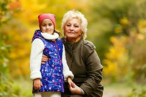 Senior citizen stroll in a park in autumn photo