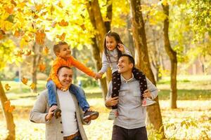 Young family having fun in the autumn park with his son. photo