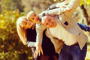 walking family with child in autumn park photo