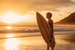 Confident boy carrying surfboard while standing at seaside in sunset photo