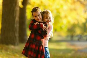 two girls in autumn park photo