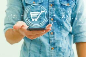 Close up of a man using mobile smart phone Businessman on blurred background using digital shopping icons with connections photo