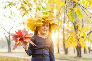 Autumn season leisure. Atmosphere of autumn. Adorable smiling schoolgirl autumn foliage background. Good mood. Happy child. Welcome october. United with nature. Little child walk in autumn park. photo