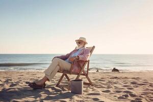 Businessman sitting in deck chair at beach photo