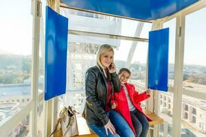 Portrait of happy mother and baby talking in big ferris wheel.Relationship concept. photo