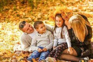 family with two children in autumn park photo