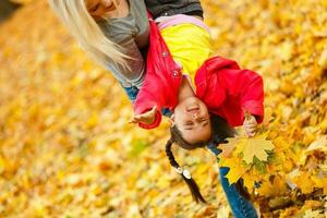 happy family mother and child daughter playing and laughing on autumn walk. photo