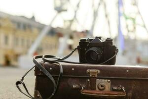 Travelling in a big city, Ferris Wheel, travel suitcase photo