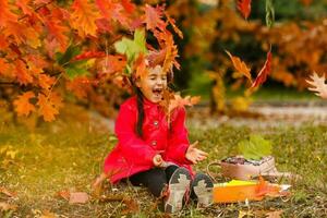 Pupil of primary school with book in hand. Girl with backpack near building outdoors. Beginning of lessons. First day of fall. photo