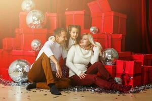 family, christmas, x-mas, winter, happiness and people concept - smiling family with many gift boxes photo