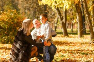 walking family with child in autumn park photo