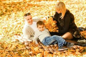 walking family with child in autumn park photo