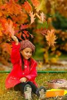 Pupil of primary school with book in hand. Girl with backpack near building outdoors. Beginning of lessons. First day of fall. photo