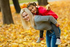 happy family mother and child daughter playing and laughing on autumn walk. photo