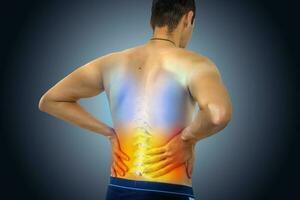 Lower back pain. Man holding his back in pain. Medical concept. photo