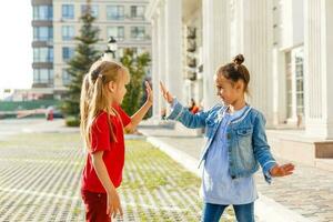 Portrait of happy fashion little girls having fun in the city photo