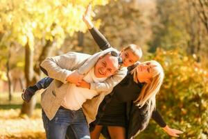 walking family with child in autumn park photo